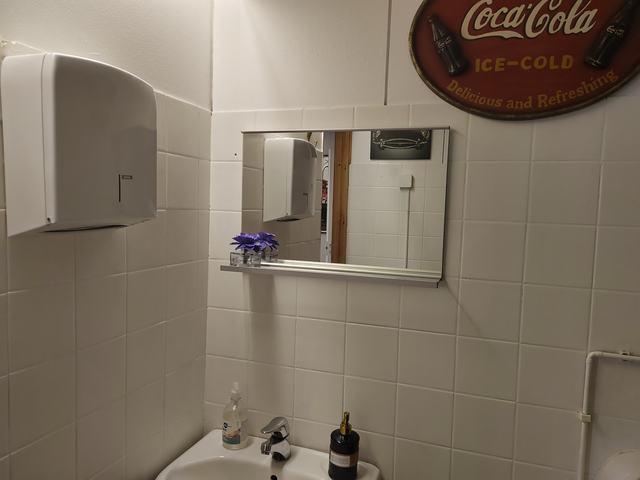 WC-tila vintage-henkisellä Coca-Cola-kyltillä